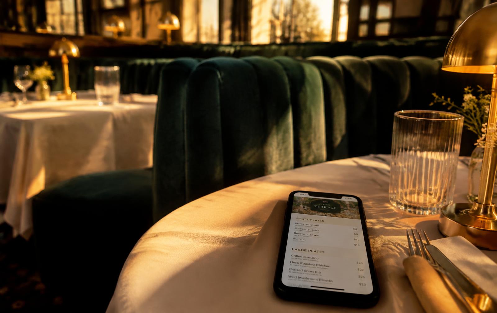 Restaurant table with a phone showing a digital menu